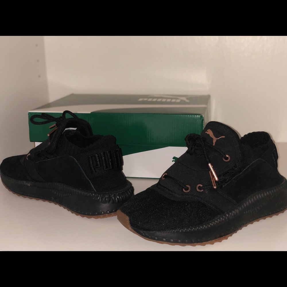 Black and rose gold Pumas